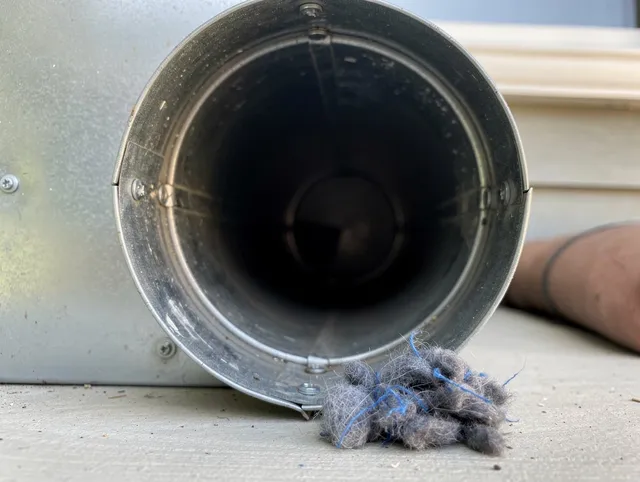 Duxbury Dryer Vent Cleaning technician using specialized equipment to clear severe dryer vent blockage in Duxbury